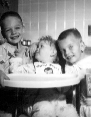 Billy Windsor, Tony Windsor, and Wendy Windsor at her highchair in 1954.