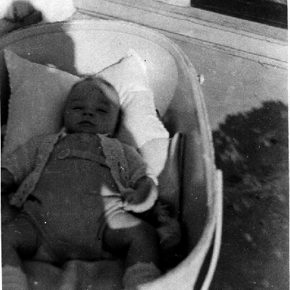 Billy Windsor in crib in shade in 1949