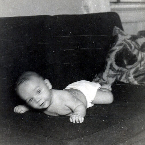 Billy Windsor on his stomach on couch in 1949