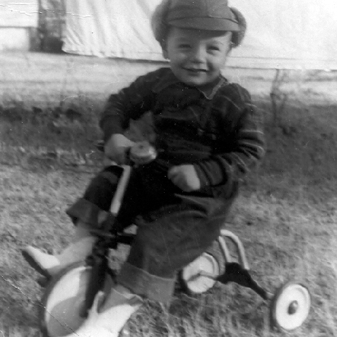 Billy Windsor on tricycle in hat in 1950